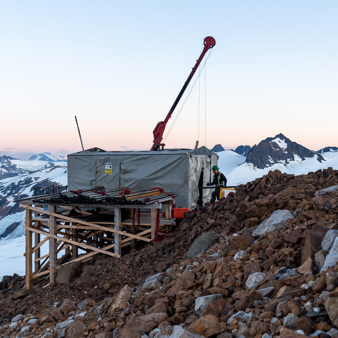 Drilling rig on a mountain peak at sunset